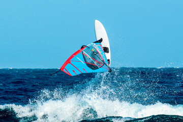 windsurfer making an acrobatic jump over the waves
