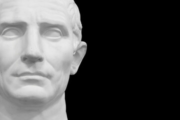 white plaster male statue isolated on black background