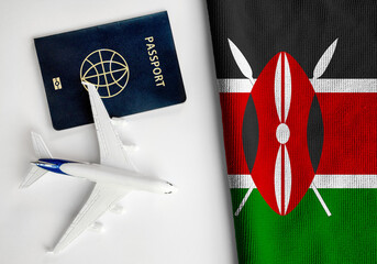 Flag of Kenya with passport and toy airplane. Flight travel concept
