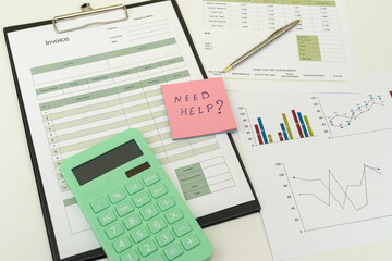 Financial paper charts with calculatop and pen on office desk