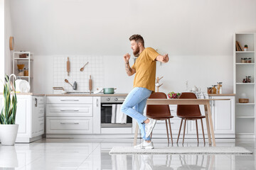 Cool young man dancing at home