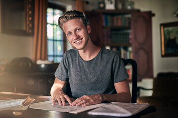 Fototapeta premium You have to think of it as self-improvement, not homework. Portrait of a diligent young student doing a homework assignment at home.