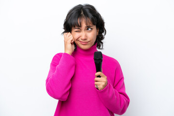 Young Argentinian singer woman isolated on white background frustrated and covering ears