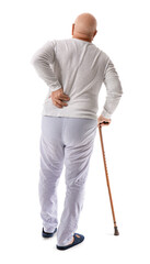Senior man with walking stick suffering from back pain on white background