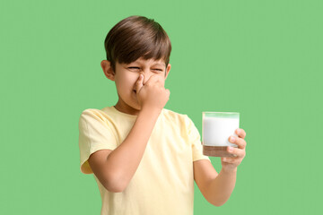 Little boy with lactose intolerance on color background