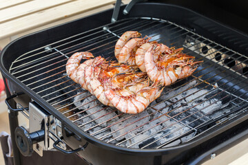 Grilled prawns on the flaming grill.