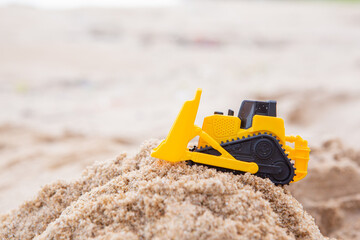 bulldozer toy yellow plastic beach sand