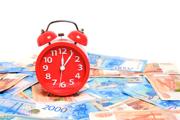 Russian rubles and red alarm clock white background.Time Russian ruble.