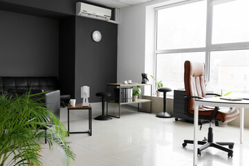 Modern office with stylish furniture and big window