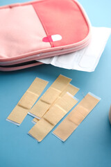 adhesive bandage and a bag on table 
