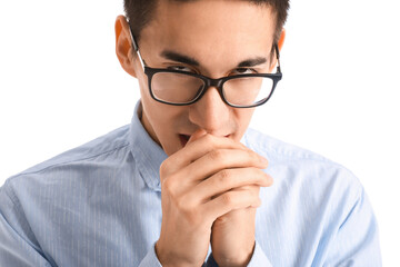 Young Asian man in eyeglasses worrying on white background, closeup