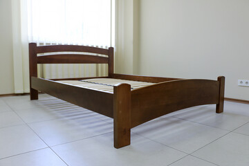 arched wooden bed with slats without mattress