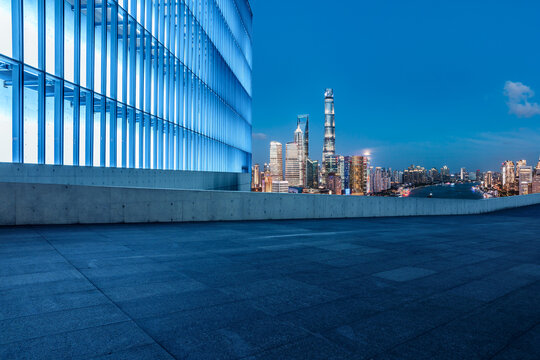 Empty square floor and city skyline with buildings in Shanghai at night, China.
