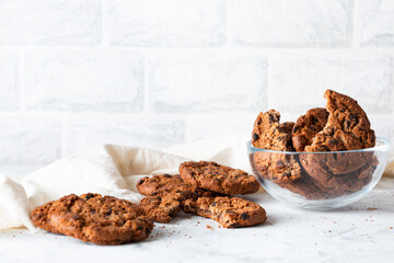 Oatmeal cookies with chocolate chips on a light background. Breakfast concept.