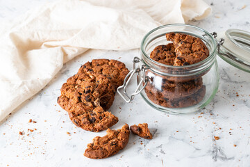 Oatmeal cookies with chocolate chips on a light background. Breakfast concept.
