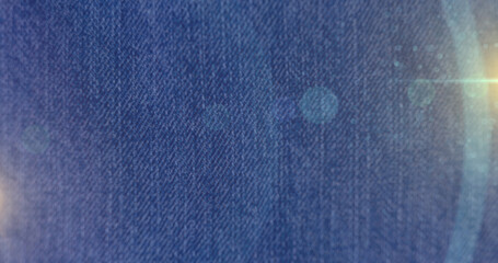 Image of light spots over denim trousers