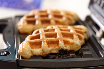 Croffle croissant and waffle. Soft and layered croissant dough is squeezed with a waffle iron and fried