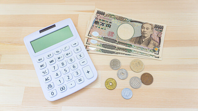 Japanese banknotes, coins and calculators placed on the table_b_01 - Powered by Adobe