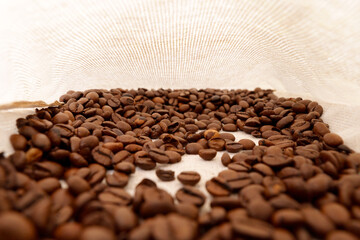 Coffee beans close-up in a bag, wide shooting angle. Selective focus