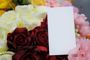 A blank business card is placed inside a bouquet