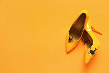 Fototapeta Female shoes with spiders on orange background. April Fool's Day prank obraz
