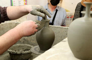 A master potter creates a clay pot on a potter's wheel in Grottaglie (City of ceramics), Taranto, Puglia, Italy