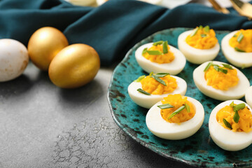 Plate with eggs on grunge background, closeup. Easter celebration