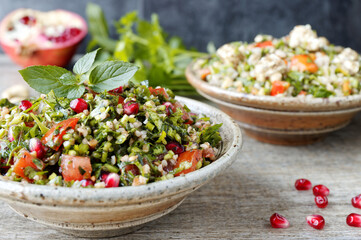Tabbouleh salad with parsley, mint, bulgur and pomegranate. Fresh salad with herbs.
