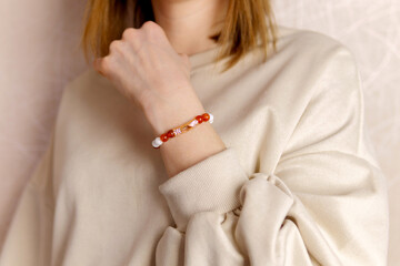 Stylish on the girl arm bracelet decoration made of agate and carnelian. Selective focus