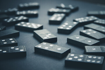 Black dominoes on dark table background