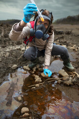 Biologist Looking at Test Tube Reaction in Hand of a Contaminated Riverbed Soil Sample