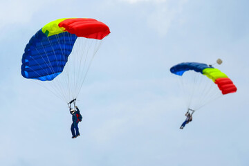 Two parachutists ready to land - skydiving