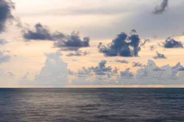 the landscape is the sea and clouds calmly and majestically floating above it. evening sunset in cold blue tones