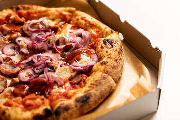 Pepperoni pizza in a box isolated on white background.Fresh fragrant and hot pizza.Copy space.