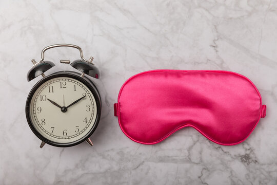 Sleeping Eye Mask And Alarm Clock On Marble Background. Minimal Rest Concept, Sleep Quality, Good Night, Insomnia, Relaxation, Sweet Dreams. Copy Space. Flat Lay, Top View Mock Up