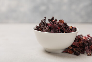 Hibiscus tea. Hibiscus tea in a white ceramic bowl on a gray cement background.Vitamin tea for colds and flu.Copy space.
