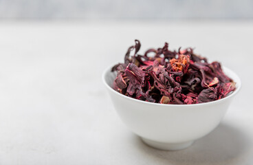 Hibiscus tea. Hibiscus tea in a white ceramic bowl on a gray cement background.Vitamin tea for colds and flu.Copy space.