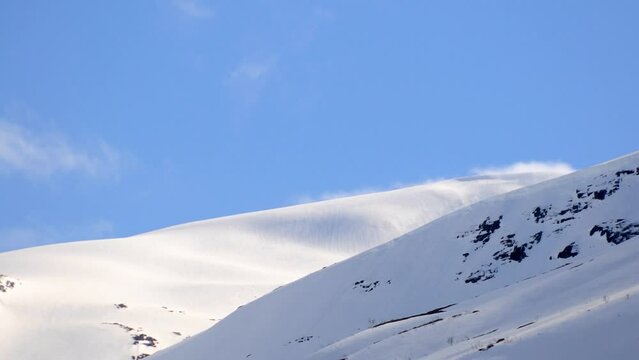 clouds rolling over snow in the mountains time lapse