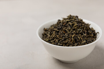 Green tea in a white ceramic bowl on a light background. tea for immunity and detox. place for text. Tea ceremony.