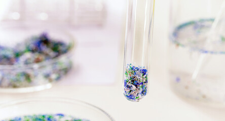 close-up of test tube with traces of plastic and micro plastic taken from the ocean, polymer particles, pollutant from the seas, environmental problem