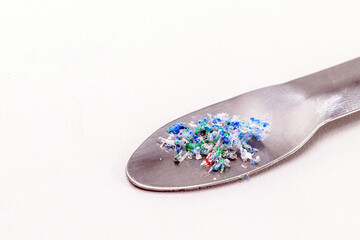 metal spatula with traces of micro plastic taken from the ocean, pollutant, polymers, being analyzed. Copy Space