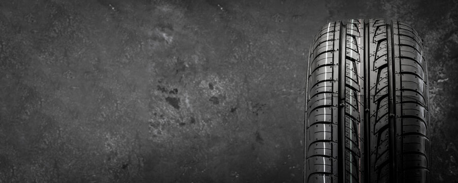 directional summer new tire on a textured background front view