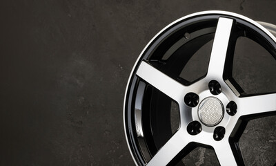 detail of beautiful black with polished front surface alloy wheel , spare parts for car copy space