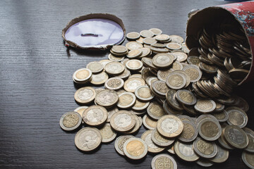 Open savings over a wooden table for financial crisis with Colombian coins