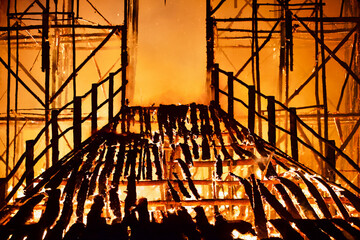Burning bridge leading to the door of a destroyed burning building. Fiery bridge through the flames...