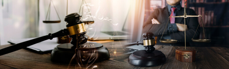 Obraz na płótnie Canvas justice and law concept.Male judge in a courtroom on wooden table and Counselor or Male lawyer working in office. Legal law, advice and justice concept.