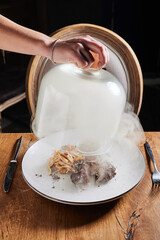 Meat under a glass cloche and fumigation with smoke sauce. Lunch break
