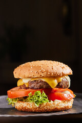 
juicy cheeseburger on the table in the restaurant. fast food concept, cheeseburger banner