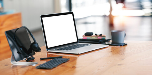 Open blank laptop in modern workplace with office supplies and decorations