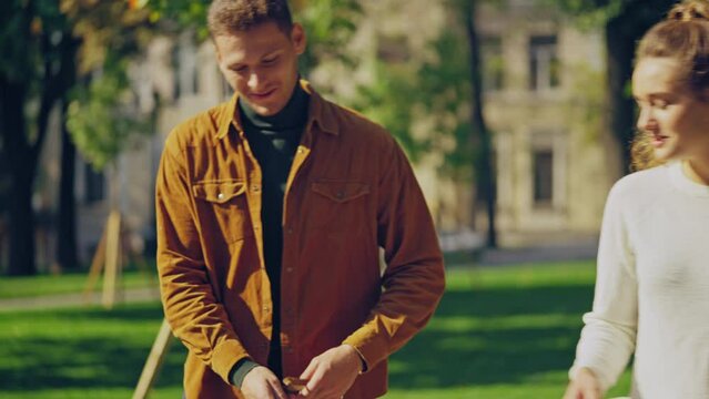 Male dog owner paying money to female dog walker, pet walking services